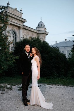 Romantic wedding couple posing in garden