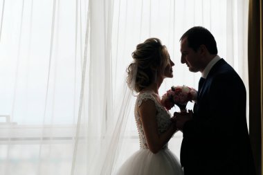 Odada poz veren yeni evlilerin yakın plan portresi.