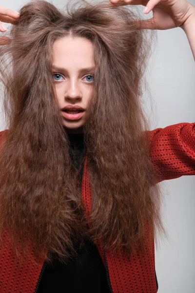 Teenager girl making faces having fun posing in studio