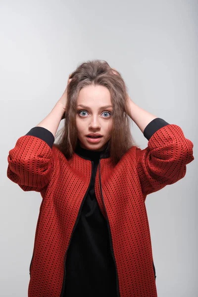 Teenager girl making faces having fun posing in studio