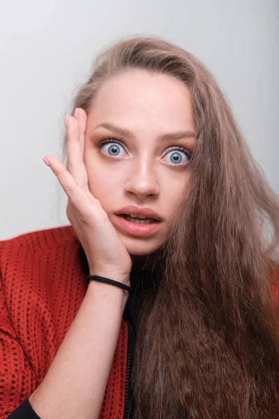 Teenager girl making faces having fun posing in studio