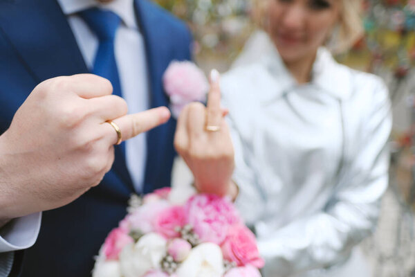 Closeup of newlyweds showing hands