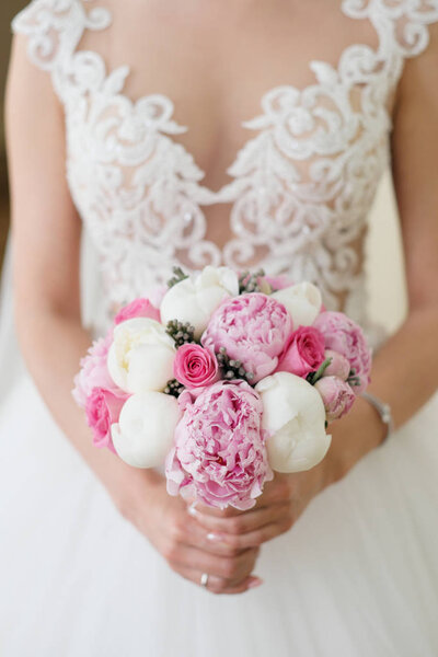 Blonde woman in wedding dress with bouquet