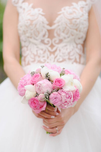 Woman in wedding dress with bouquet
