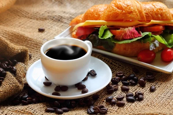 Croissant sandwich and hot coffee for breakfast. Royalty Free Stock Images