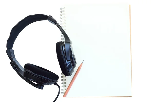Oortelefoon en notebook. — Stockfoto