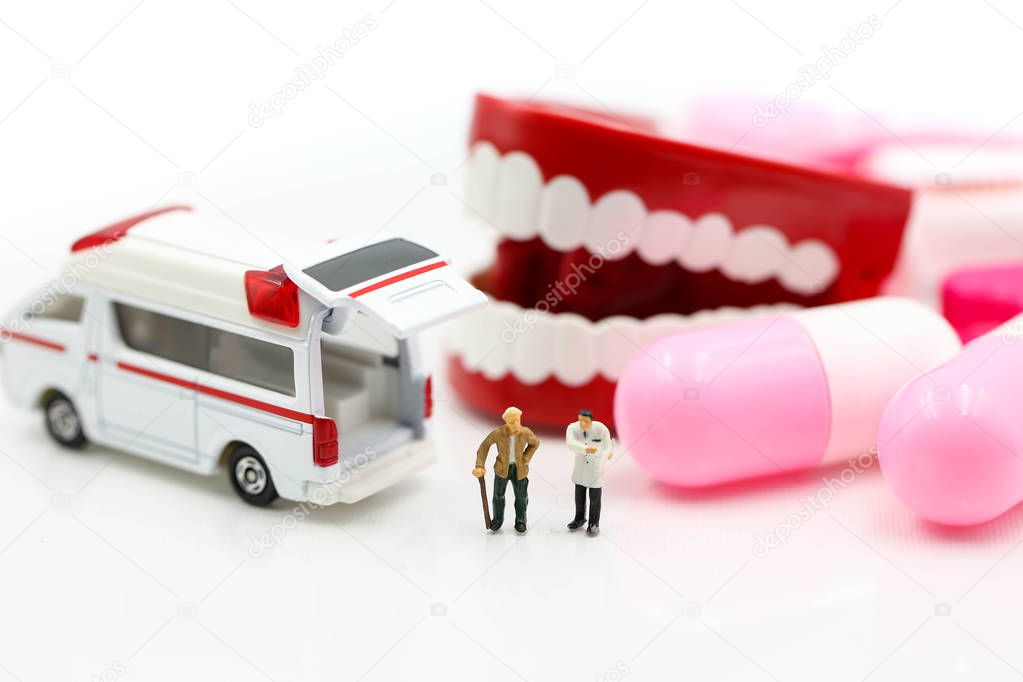 Miniature people : Doctor and Paramedic attending to patient in 