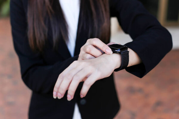 Beautiful Young businesswoman   looking at her smart watch