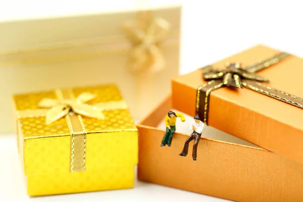 Miniaturmenschen: Liebespaar mit Geschenkbox, Liebeskonzept. — Stockfoto