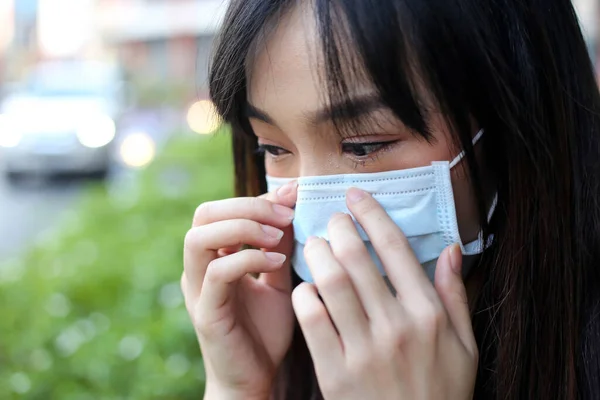 Beautiful asia woman wearing mouth mask against air smog polluti