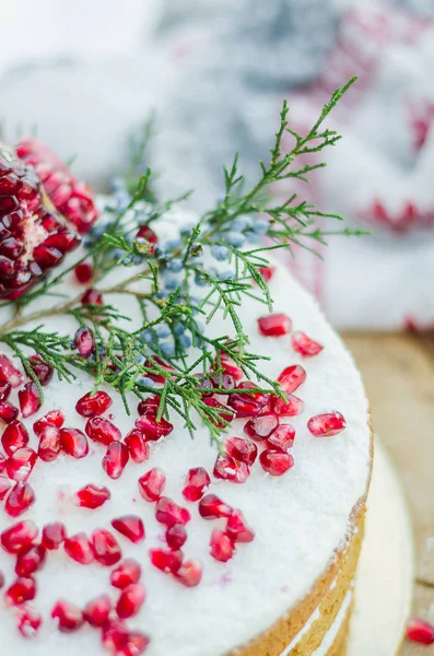 A beautiful chocolate cake with cheese cream, meringues, chocolate and fresh pomegranate. Provence style. The original idea for a wedding cake or birthday cake.
