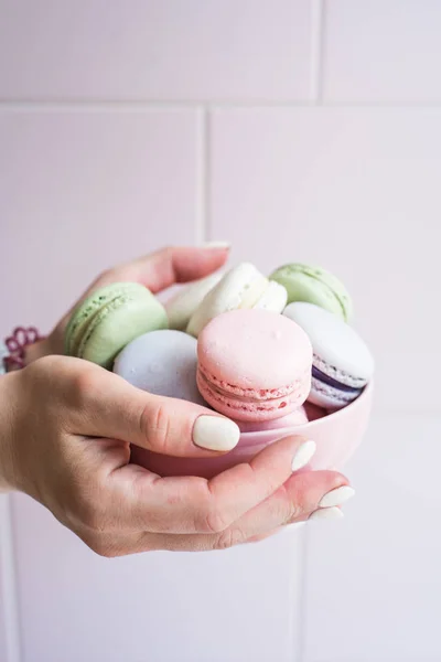 Plate with diferent macaroons in the hands of a girl — Stock Photo, Image