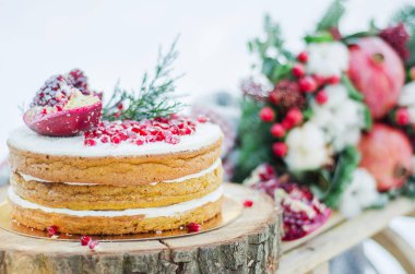 Handmade brown biscuit cake decorated with garnet with cream