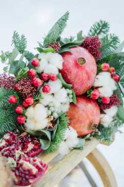 Winter bridal bouquet with garnet and green tree