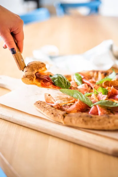 Delicious pizza stands on the table, pizza with red sauce, pancetta and basil, Italian cuisine, pizzeria — 图库照片