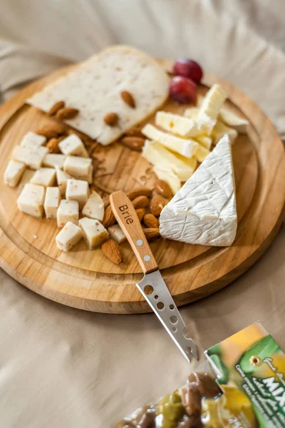 Cheese plate served with nuts, Top view. Assorted cheeses Camembert, Brie, Parmesan blue cheese, goat — Stock Photo, Image