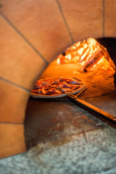 Original neapolitan pizza margherita in a traditional wood oven in restaurant