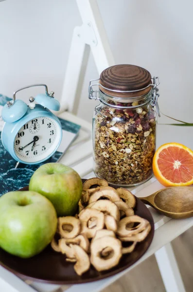 Homemade healthy granola in the glass jar on white table in the kitchen — Stock Photo, Image