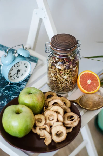 Homemade healthy granola in the glass jar on white table in the kitchen — Stock Photo, Image