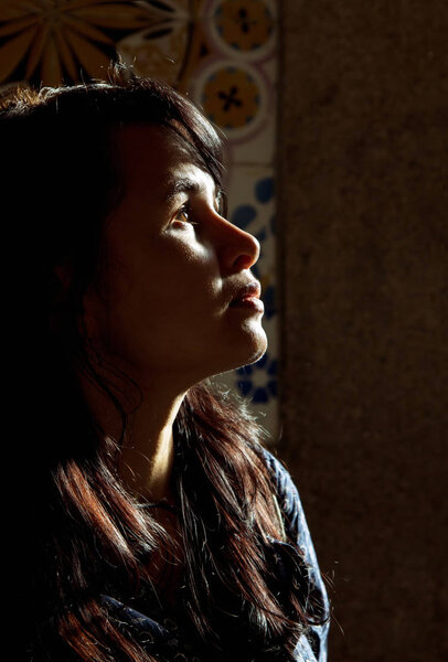 Backlight profile of a young beautiful woman