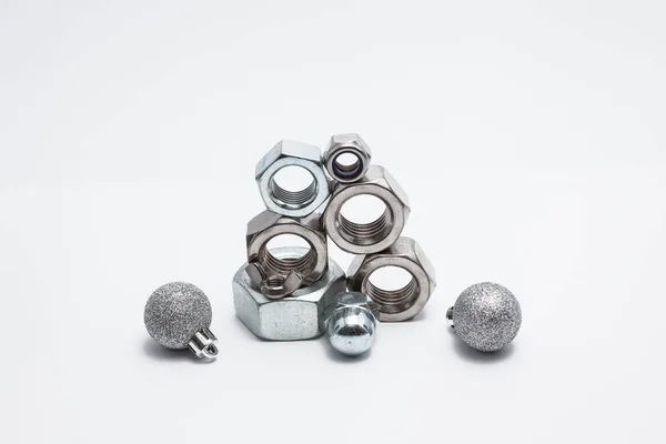 Several iron bolts and christmas balls — Stock Photo, Image