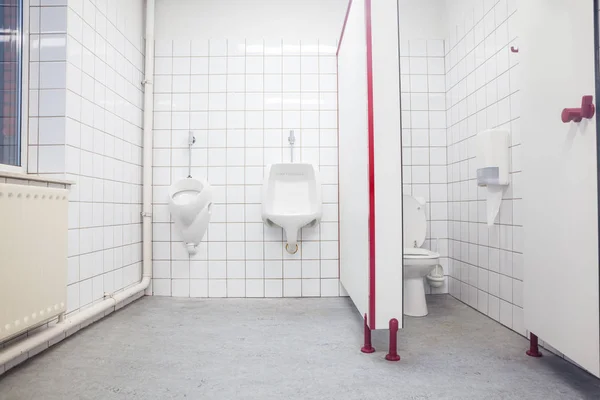 Urinal and toilet door — Stock Photo, Image