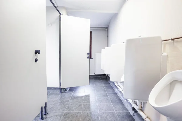 Urinal and toilet doors — Stock Photo, Image