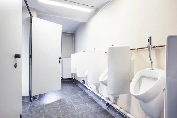 Urinal and toilet doors — Stock Photo, Image