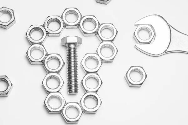 Bolts and nuts and a spanner — Stock Photo, Image