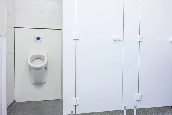 Urinal and toilet doors — Stock Photo, Image