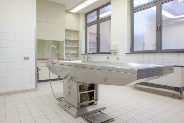 Autopsy tables in morgue clipart