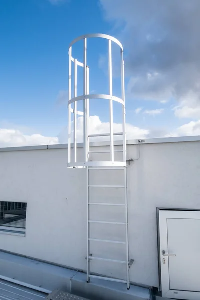 on an roof of an building there is an emergency staircase