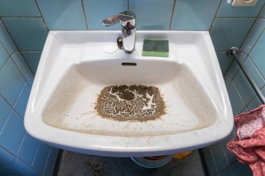 Öğrenci odasında kirli bir lavabosu var.