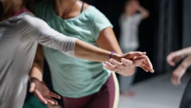 dancer foot, hand  contacting, subject intentionally out of focus