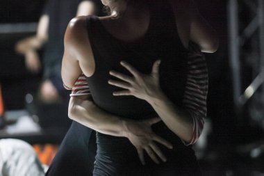 dancer foot, hand  contacting, subject intentionally out of focus