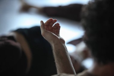 dancer foot, hand  contacting, subject intentionally out of focus