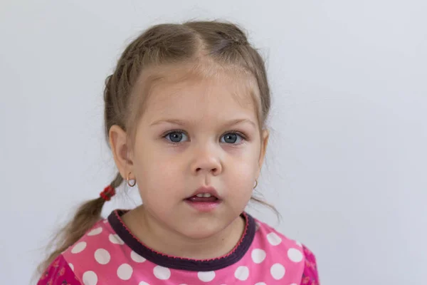 Portrait of caucasian child of three years old with calm face looking at camera on the white background — Stock Photo, Image