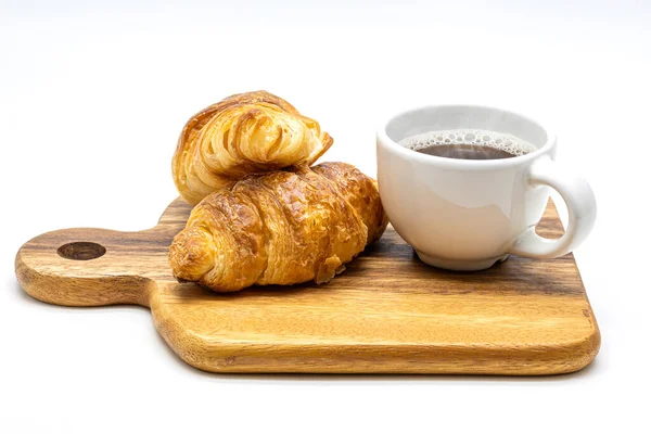 A white cup of hot coffee with croissant on wooden tray isolate Stock Photo