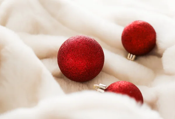 Bugigangas de Natal vermelho no fundo de pele macia branca, winte luxo — Fotografia de Stock