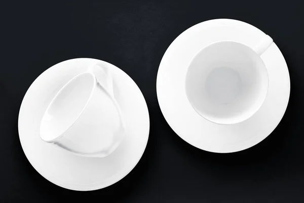 White tableware crockery set, empty cup on black flatlay backgro