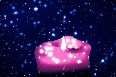 Mavi köpüklü kar arka plan üzerinde pembe tatil mum, lüks