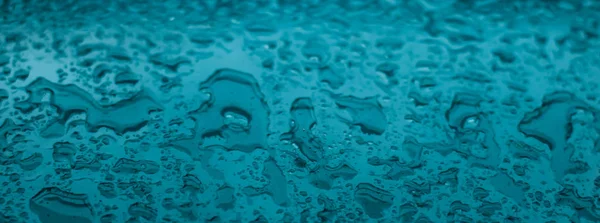 Water texture abstract background, aqua drops on turquoise glass