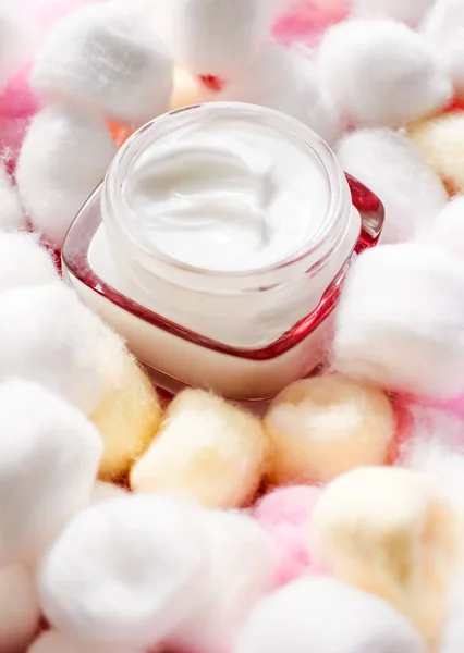 Luxury face cream for sensitive skin and eco cotton balls on bac