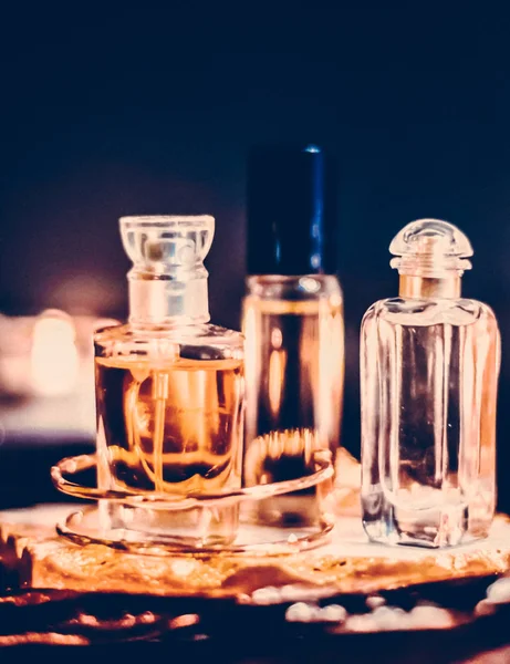 Perfume bottles and vintage fragrance at night, aroma scent, fra