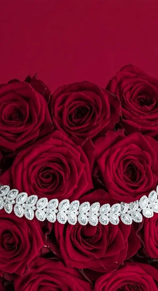 Luxury diamond jewelry bracelet and red roses flowers, love gift