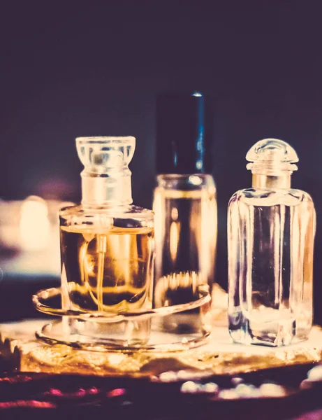 Perfume bottles and vintage fragrance at night, aroma scent, fra Stock Image