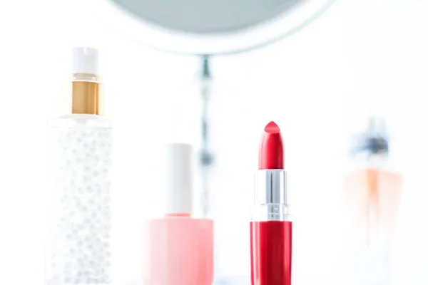 Cosmetics, makeup products on dressing vanity table, lipstick, f