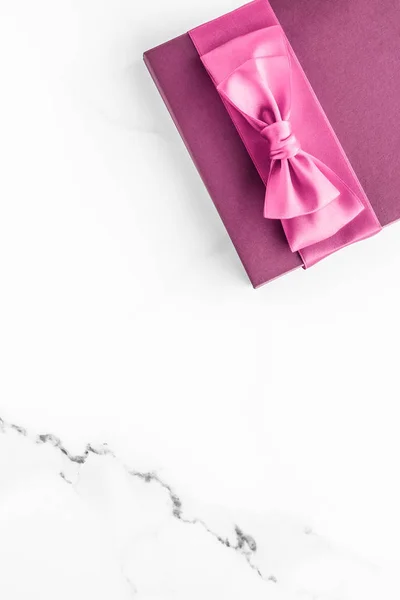 Różowe pudełko z jedwabną kokardą na marmurowym tle, dziewczyna baby show — Zdjęcie stockowe