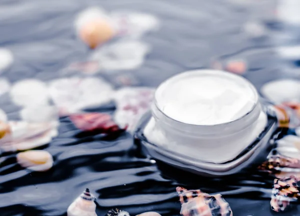 Sensitive skincare moisturizer beauty face cream on water and se — Stock Photo, Image