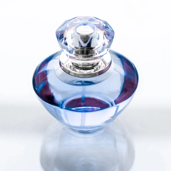 Frasco de perfume azul sobre fundo brilhante, aroma floral doce, gl — Fotografia de Stock